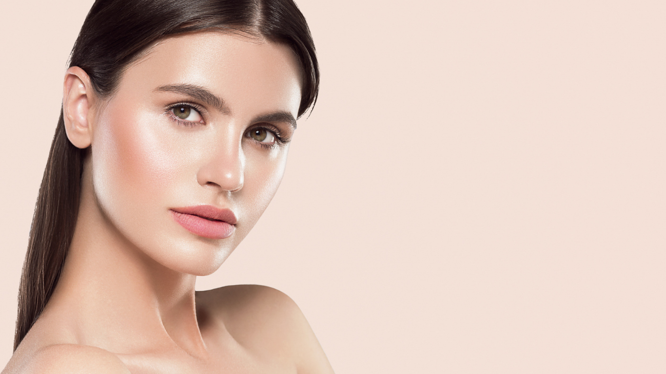 Model with radiant skin wearing Teint Naturelle Foundation in Champagne Silk. Smooth, glowing finish for light skin tones.