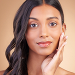Model with glowing complexion wearing Teint Naturelle Foundation. Lightweight base perfect for deep skin tones.