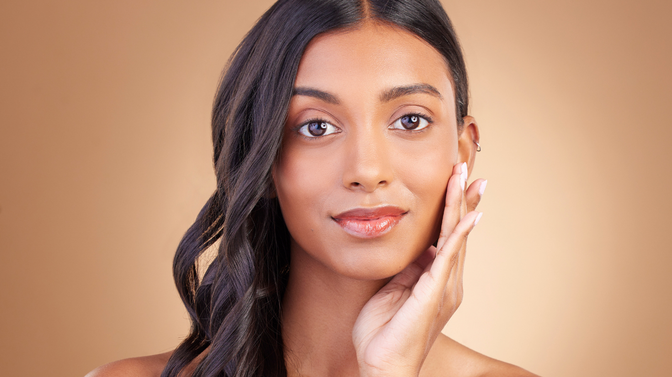 Model with glowing complexion wearing Teint Naturelle Foundation. Lightweight base perfect for deep skin tones.