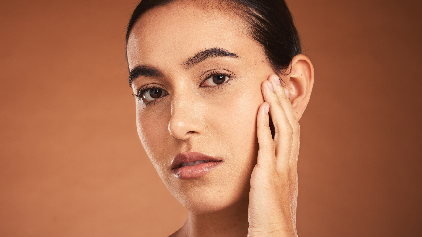 Model with warm skin tone showcasing Teint Naturelle Foundation. Enhances complexion with breathable formula.