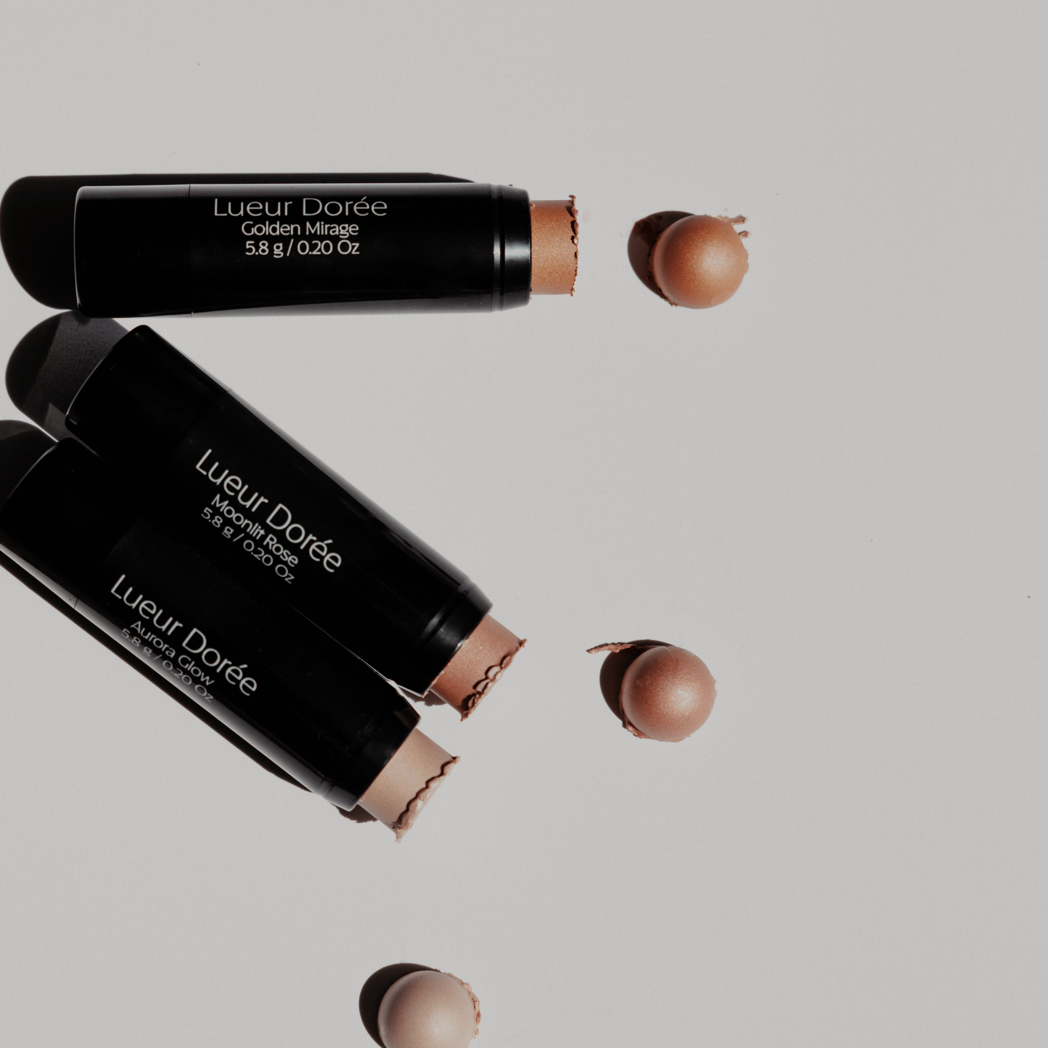 Lueur Dorée Highlighters in Golden Mirage shades with creamy texture and radiant finish, ideal for dewy glow makeup looks.