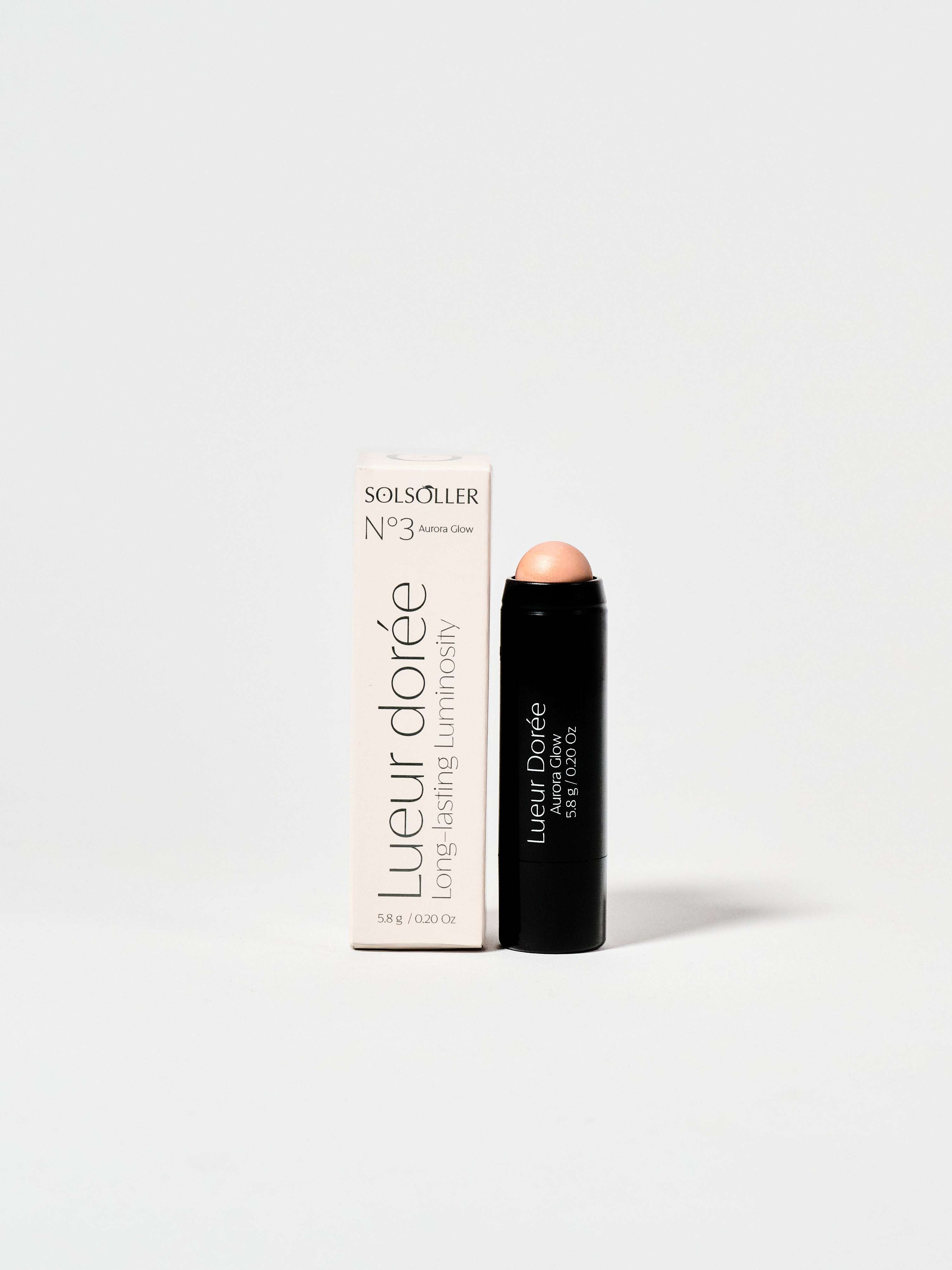 Aurora Glow Highlighter - Pink Pearlescent Glow by Rad shown with packaging and twist-up stick design for easy application.