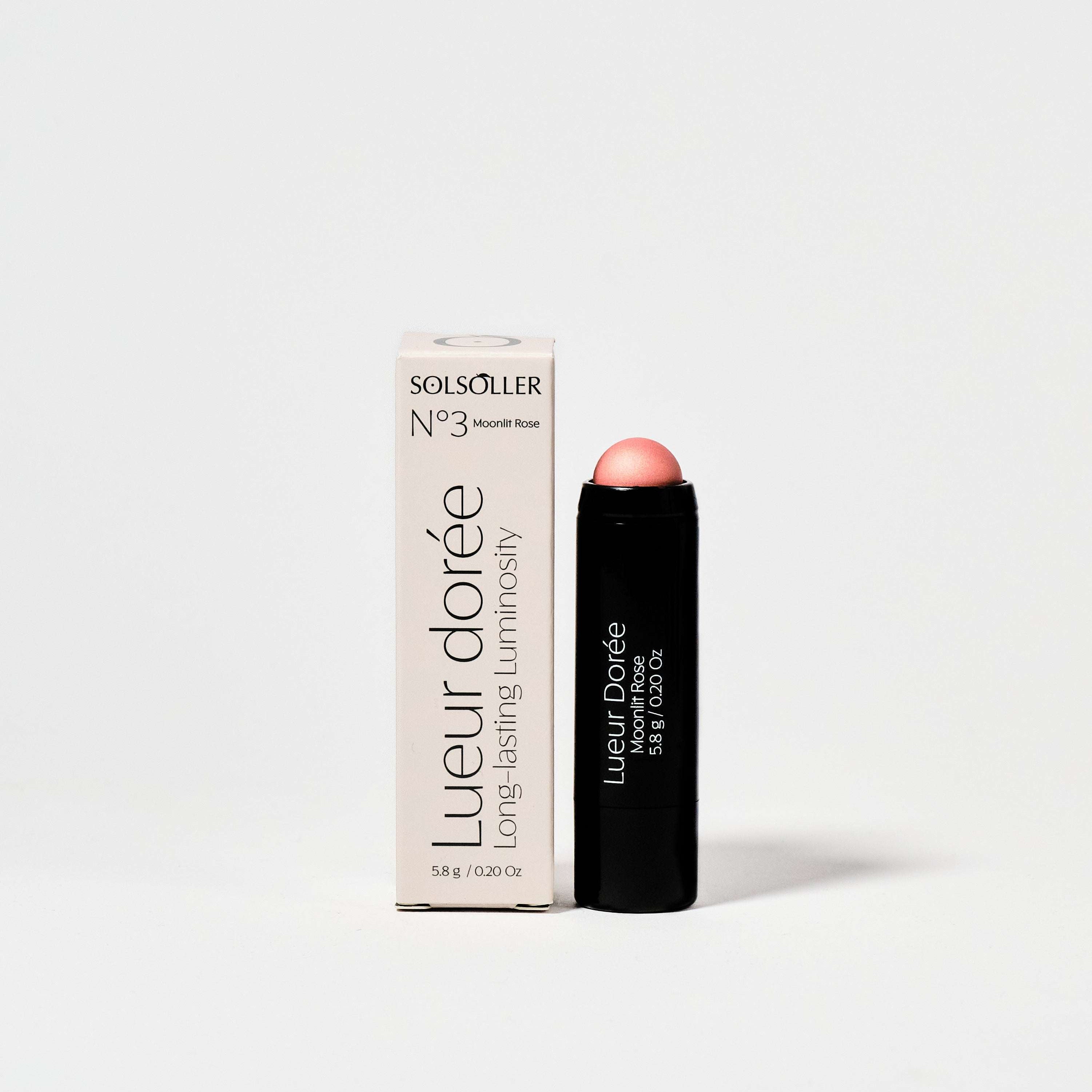 Moonlit Rose - Champagne Rose Highlighter in sleek black stick packaging with box, offering radiant glow and 13hr wear for face makeup.