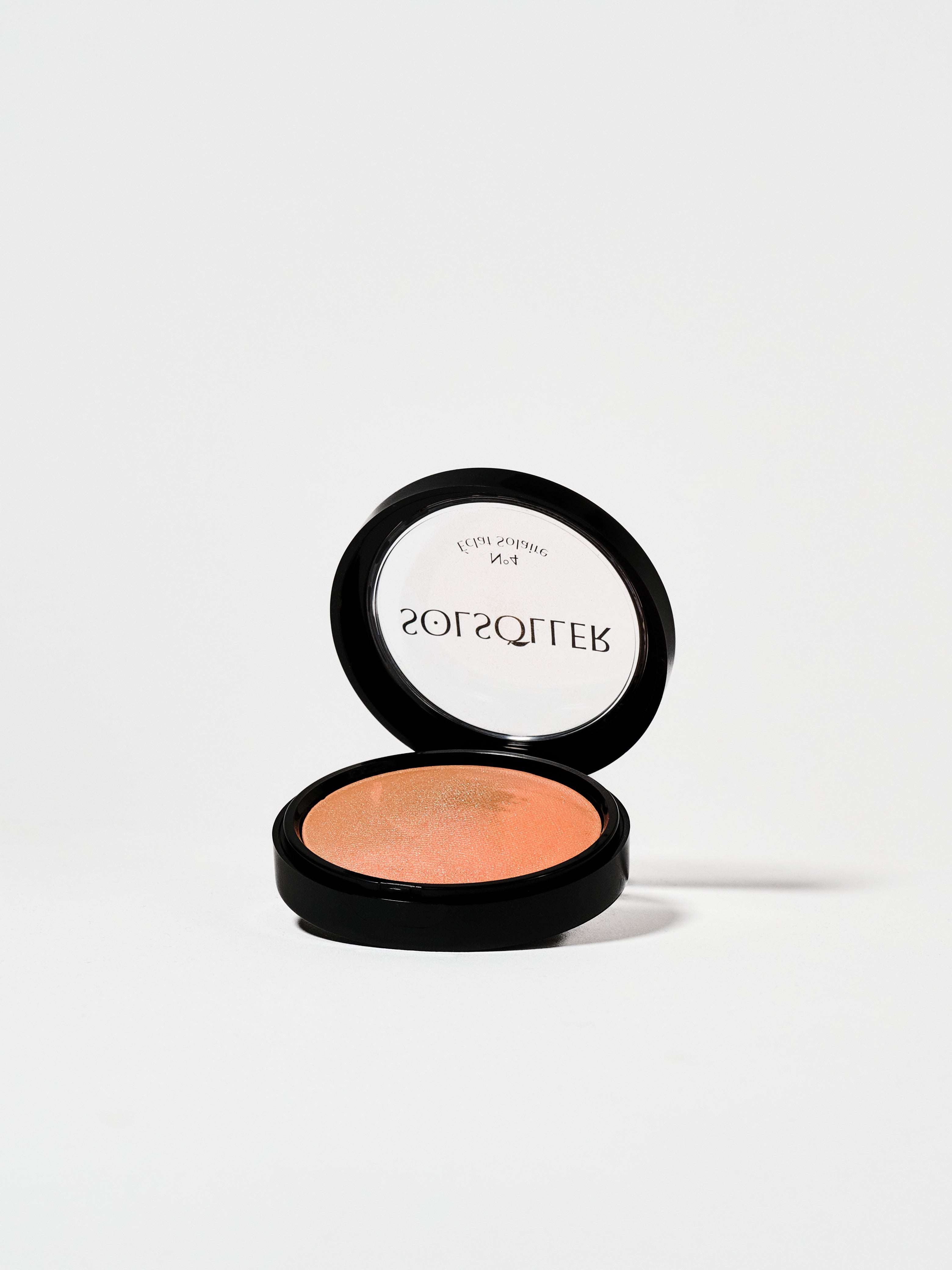 Sunkissed Blush-Bronzer in open compact with radiant peachy tone. Silky glow finish ideal for all-day wear and buildable face makeup.
