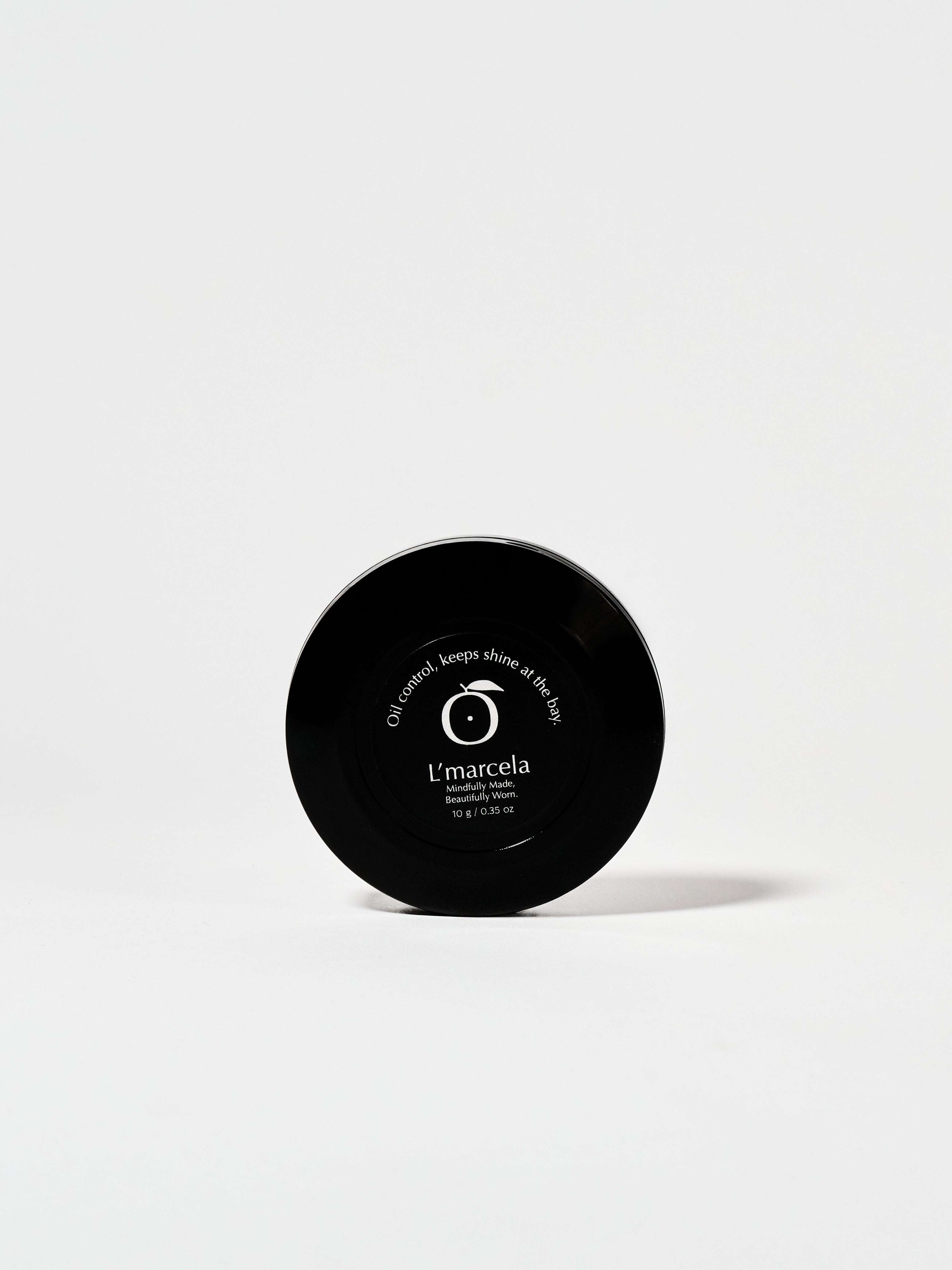 Back view of L'marcela: Long-Lasting and Pore-Friendly Baby Pink Setting Powder compact, highlighting oil control and 10-hour shine-free wear.