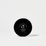 Bottom view of L’Marcela Setting Powder compact with product label, emphasizing its long-lasting, shine-controlling formula.