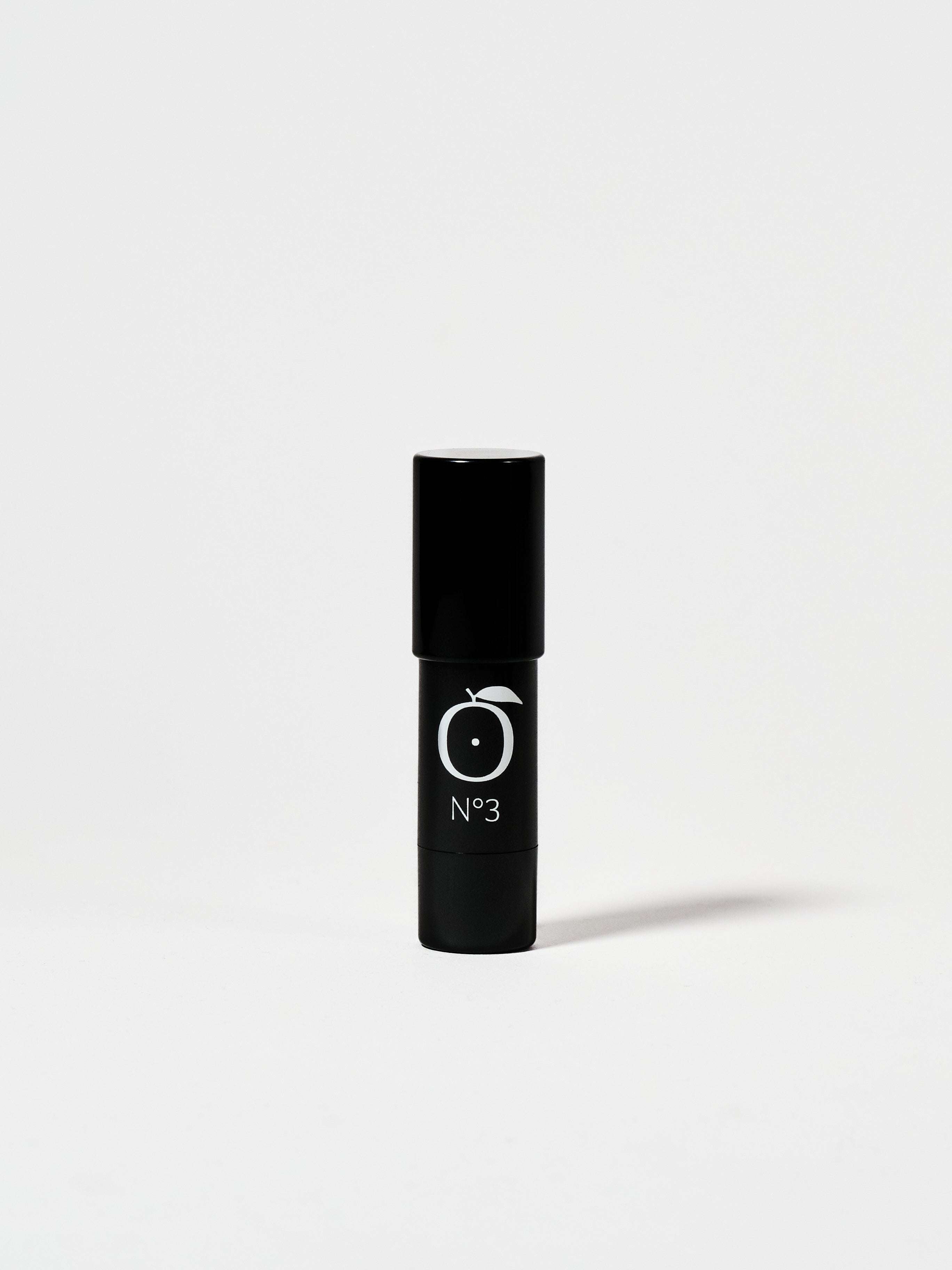 Aurora Glow Highlighter - Pink Pearlescent Glow by Rad in sleek black tube with No.3 label, ideal for on-the-go face makeup.