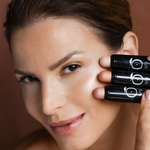 Model applying Lueur Dorée Highlighter Sticks in three shades for a dewy glow and luminous finish on mature skin.